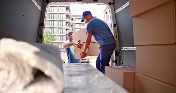 Male Movers In Uniform Loading Delivery