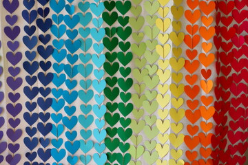 Multicolored paper hearts. Background of big and small hearts.