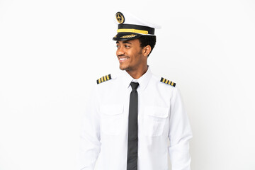 African American Airplane pilot over isolated white background looking side