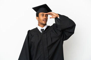 African American university graduate man over isolated white background looking far away with hand to look something