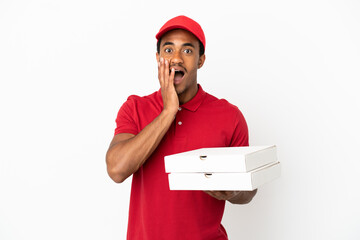 African American pizza delivery man picking up pizza boxes over isolated white wall with surprise...