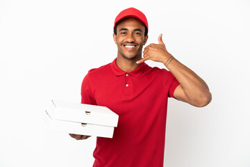 African American pizza delivery man picking up pizza boxes over isolated white wall making phone...