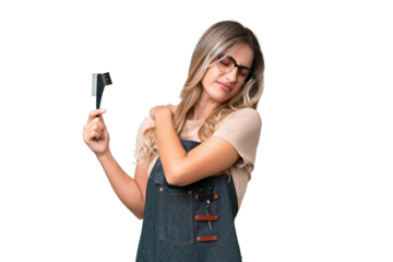 Young Uruguayan hairdresser woman over isolated background suffering from pain in shoulder for having made an effort