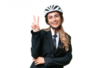 Business Uruguayan woman wearing a helmet biker over isolated background smiling and showing victory sign