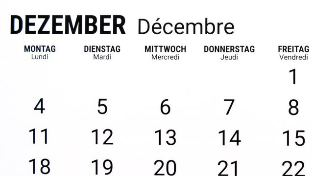 Time lapse zoom in motion of calendar month of December in german and french