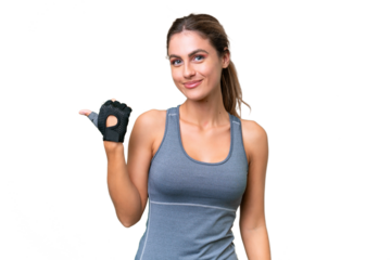 pretty Sport Uruguayan woman over isolated background pointing to the side to present a product