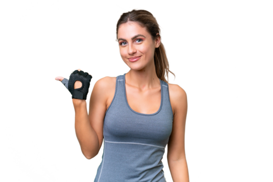 pretty Sport Uruguayan woman over isolated background pointing to the side to present a product
