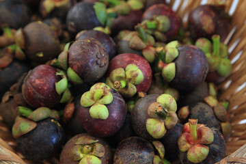 mangosteen on rattan basket. Tropical fruit for healthy eating