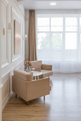 modern cozy soft interior design of a room with a bedroom and a home office in warm delicate pastel pink and beige colors
