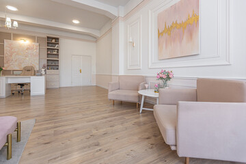 modern cozy soft interior design of a room with a bedroom and a home office in warm delicate pastel pink and beige colors