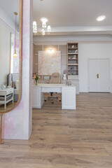 a close view of the home office in a modern cozy soft interior in warm delicate pastel pink and beige colors