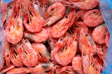 Frozen boiled shrimps. Seafood product. Full frame. Food background. Top view