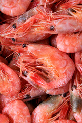 Close-up of frozen boiled shrimps. Seafood product. Full frame. Top view