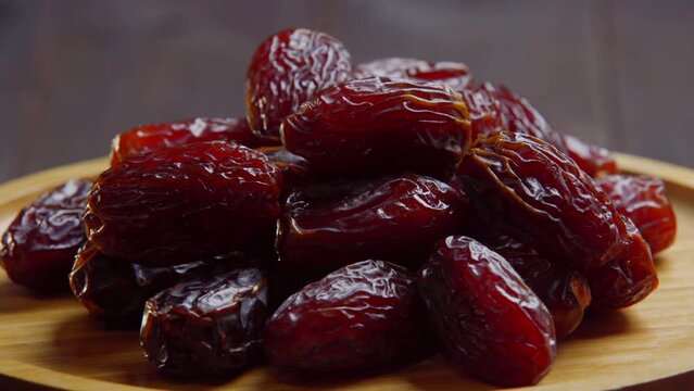 sweet dried dates in a spinning wooden bowl