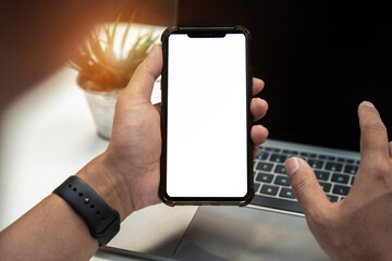 Man holding smartphone with blank screen, close-up of hands. Space for text.