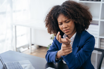 Woman have wrist pain after work hard in office feeling so pain and illness with Office syndrome symptom, healthcare office syndrome concept.
