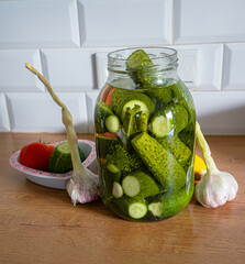 Ogórki zielone kiszone małosolne słoik. Pickled green cucumbers in a jar - obrazy, fototapety, plakaty