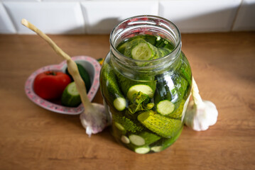 Ogórki zielone kiszone małosolne słoik. Pickled green cucumbers in a jar - obrazy, fototapety, plakaty
