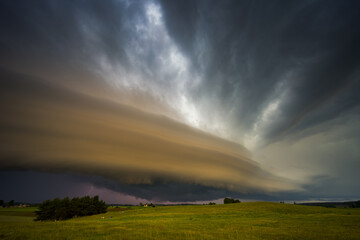 Angry supercell storm influenced by Climate change. Dangerous storm supercell shelf cloud with layers.