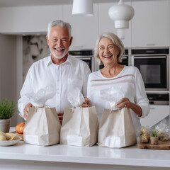 Fototapeta na wymiar Smiling grandparents holding grocery shopping bag at home