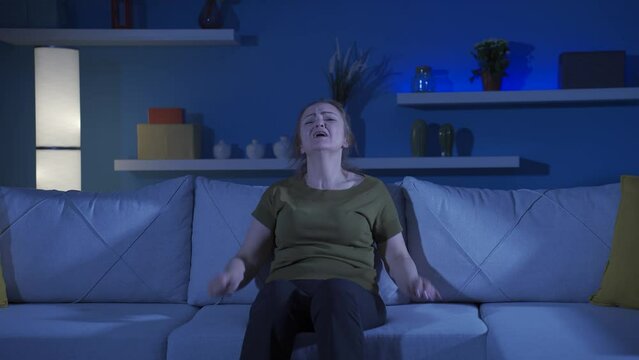 Woman slapping herself with a nervous breakdown.