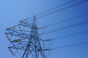 Electricity power lines against clear blue sky. Tower structure of electric pylon. Energy and industry 