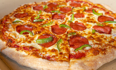 Pepperoni Pizza in Cardboard Delivery Box Closeup, Salami Pizza with Green Paprika, Chili Pepper