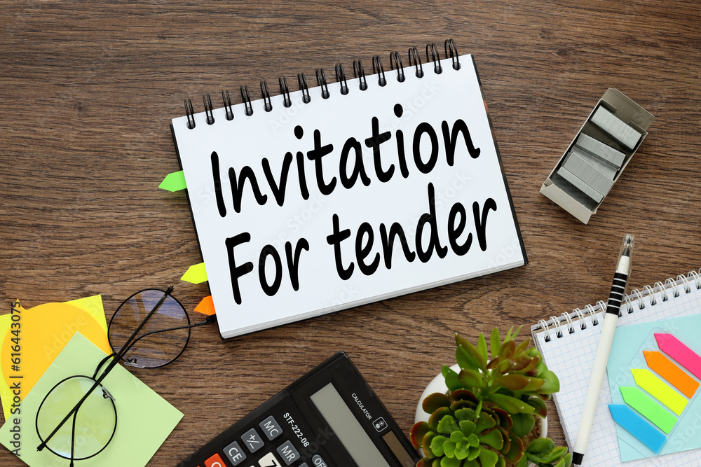Poster on a wooden background an open notepad with bookmarks. word on page. invitation for tender,
