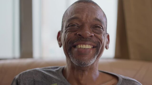 One joyful middle-aged black man smiling at camera. Portrait close-up face of a happy Brazilian person