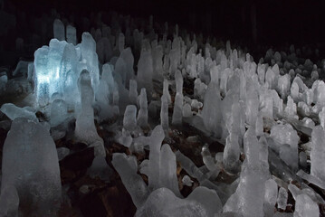 Russia. Kuril Islands. Cave with numerous ice stalagmites on the island of Iturup. During the time...
