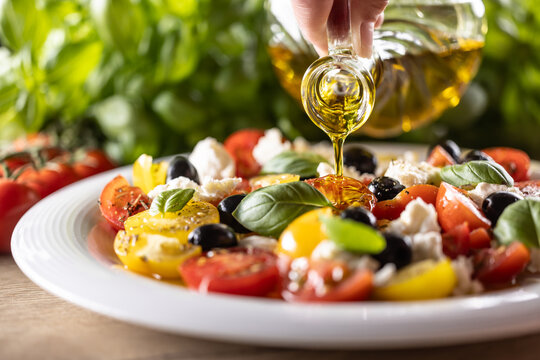 Caprese salad is oiled with olive oil