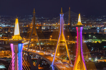 Aerial view of Bhumibol Bridge and Chao Phraya River in structure architecture concept, Urban city, Bangkok. Downtown area at night, Thailand
