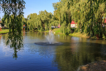 The fountain in the middle of the pond in the city of Fagaras. Transylvania. Romania