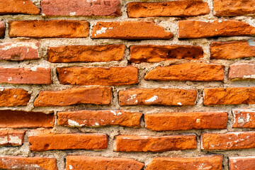 Old red brick texture wall, white seams, close up