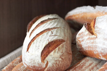 Background, sourdough bread or closeup in bakery of fresh loaves, carbs and rustic grain for nutrition. Artisan confectionery, food industry or selection of baked buns in cafe, grocery store or diner