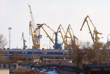Fototapeta na wymiar Harbor, port and crane for shipping, outdoor and buildings for industry, manufacturing and supply chain. Urban shipyard, machine and equipment for trade, export and infrastructure for distribution