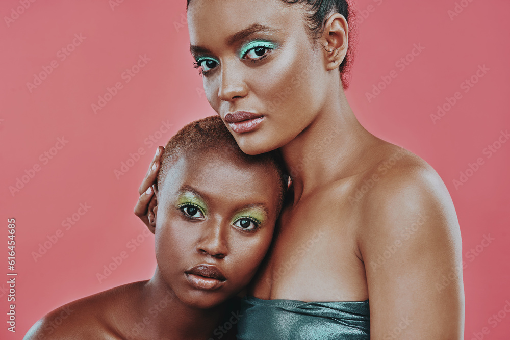 Canvas Prints Woman friends, color makeup and art in studio portrait with beauty, cosmetics and hug by pink background. Women together, model and fashion with trendy cosmetic, futuristic aesthetic and eye shadow