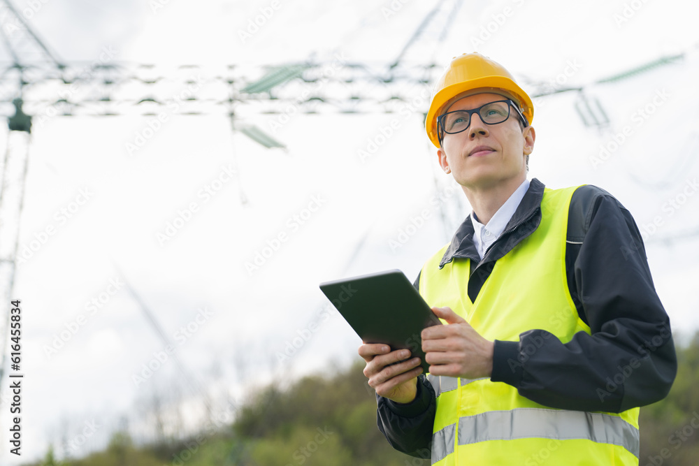 Aufkleber Engineer with digital tablet on a background of power line tower.