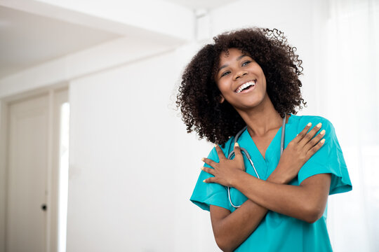 Embrace equity on multiracial Internal Women's Day. Photo of Africa American pretty cheerful nurse folded crossed arms beaming smile at home clinic