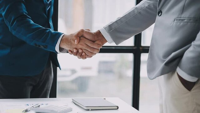 Business handshake for teamwork of business merger and acquisition,successful negotiate,hand shake,two businessman shake hand with partner to celebration partnership and business deal concept