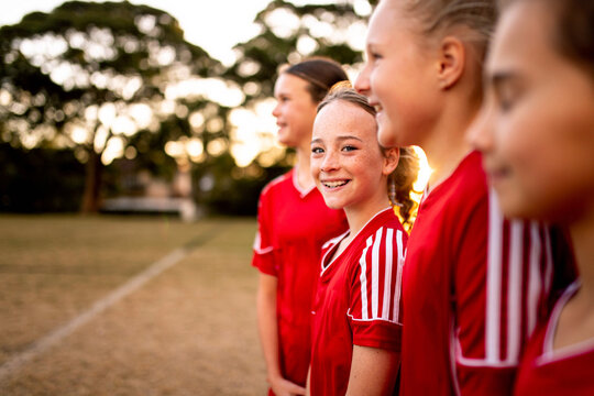 A tween girls football team training together at a sports oval