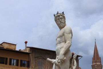 Fountain of Neptune, statue of Neptune closeup, cloudy day of summer, Piazza della Signoria, Florence, Italy.