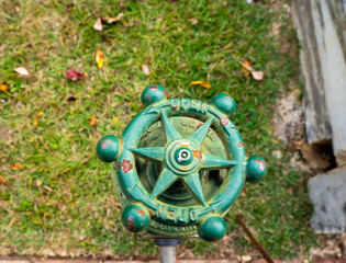 A vintage water lever and pipe. Water pipe was frequently made of cast iron in the 1800s. This material is known for its durability, but it is heavy and expensive to produce, thus plastic was chosen.