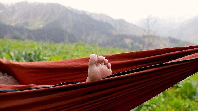 Woman relaxing in the hammock in the forest