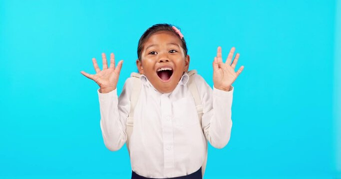 Wow, face and girl child hand pointing in studio for back to school sale, announcement or promo on blue background. Happy, news and kid portrait with kindergarten deal, coming soon or discount info