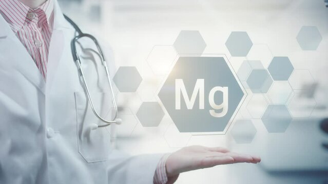 Pharmacy expert doctor showing symbol for the chemical element and mineral magnesium Mg. Clean abstract commercial background