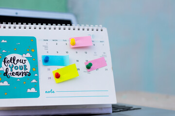 events planner reminder concept, pushpins marks on blank multicolour empty sticky notes 