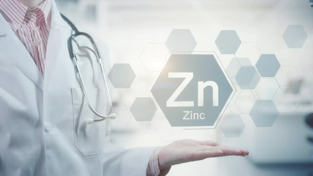Pharmacy expert doctor showing symbol for the chemical element and mineral Zinc Zn. Clean abstract commercial background
