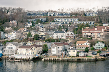 Fototapeta na wymiar Houses on Mountain Along Water at Beach in Highlands, New Jersey