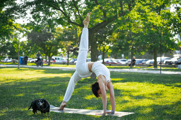 Sporty young Caucasian woman doing yoga practice concept of healthy life and natural balance...